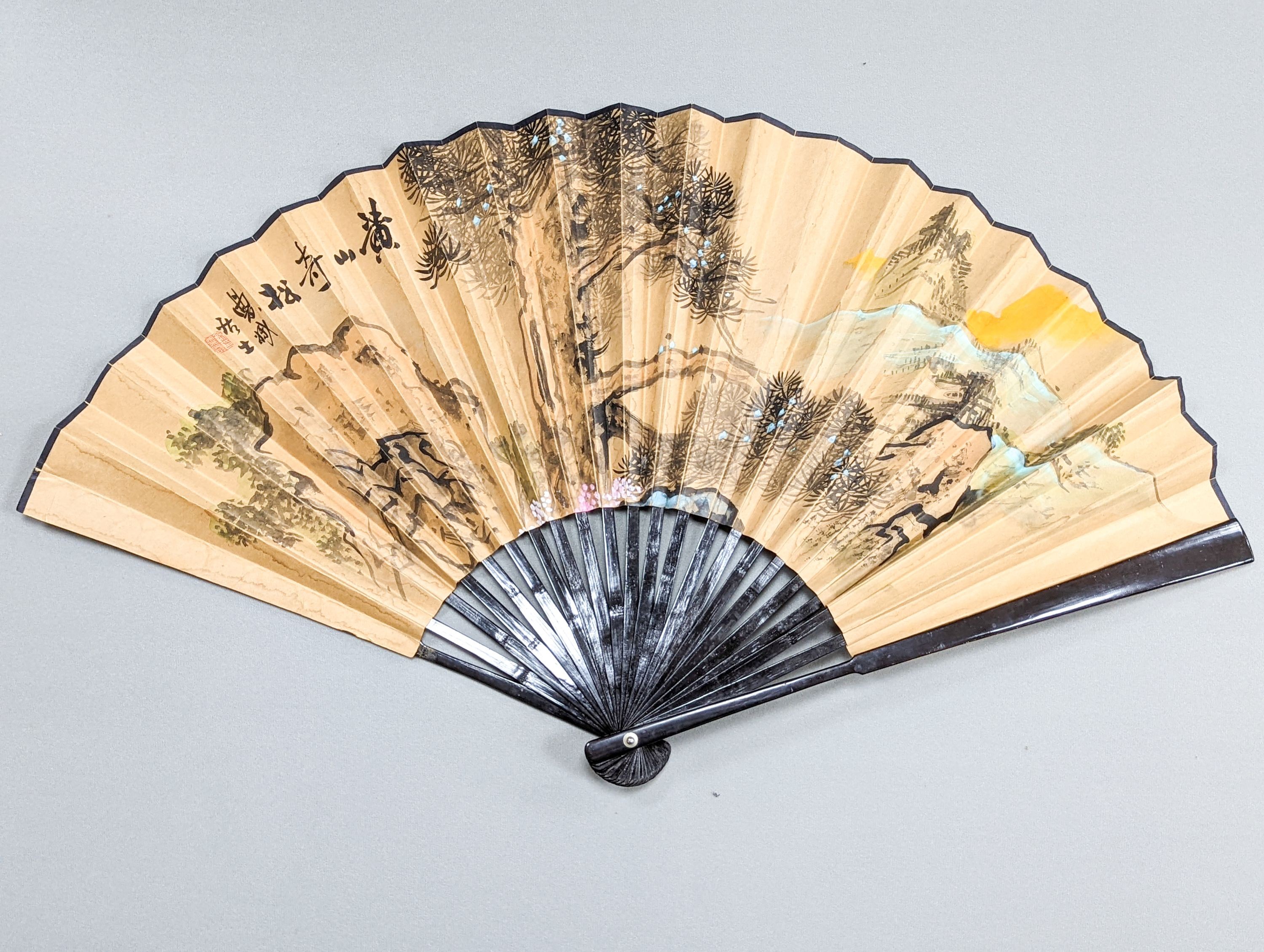 A large Chinese fan, the leaf painted with a landscape, signed Radius 60cm